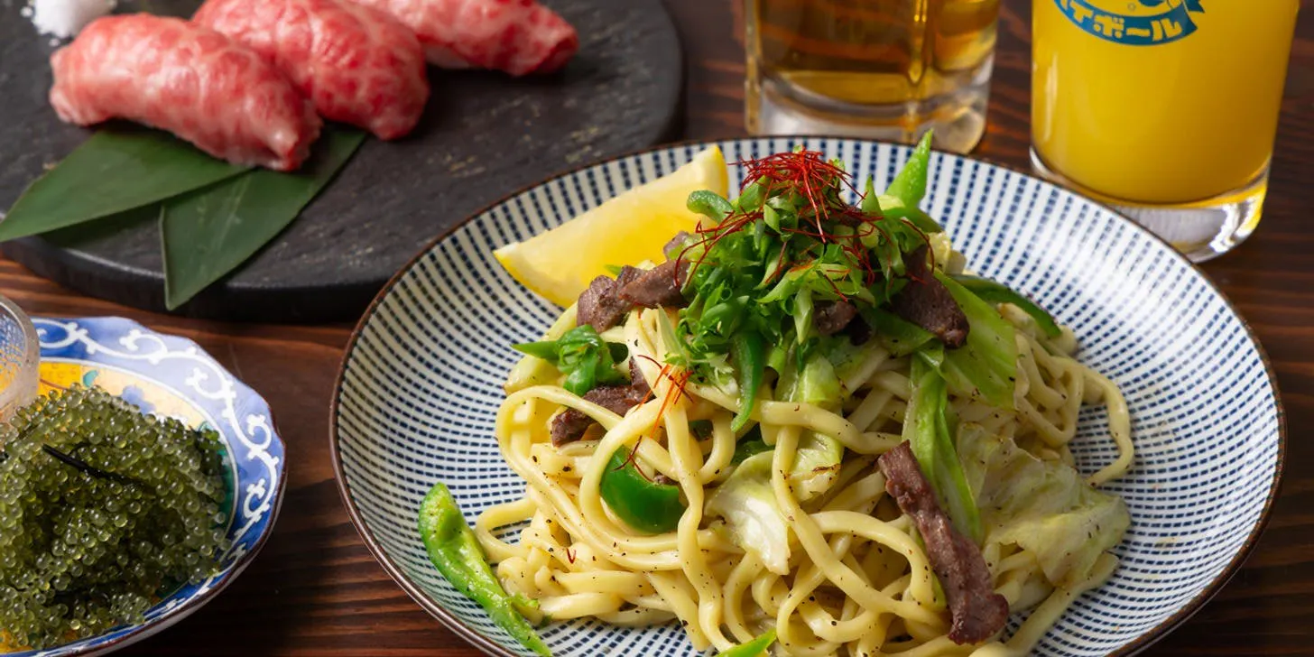 Second-floor menu offering classic selections such as char-grilled local chicken, Japanese-style ajillo, and grilled beef tongue yakisoba.